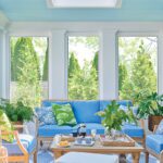 Sun room with bright blue furniture and a view of the garden