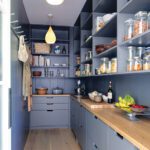Gray blue pantry with open shelving and wood countertops