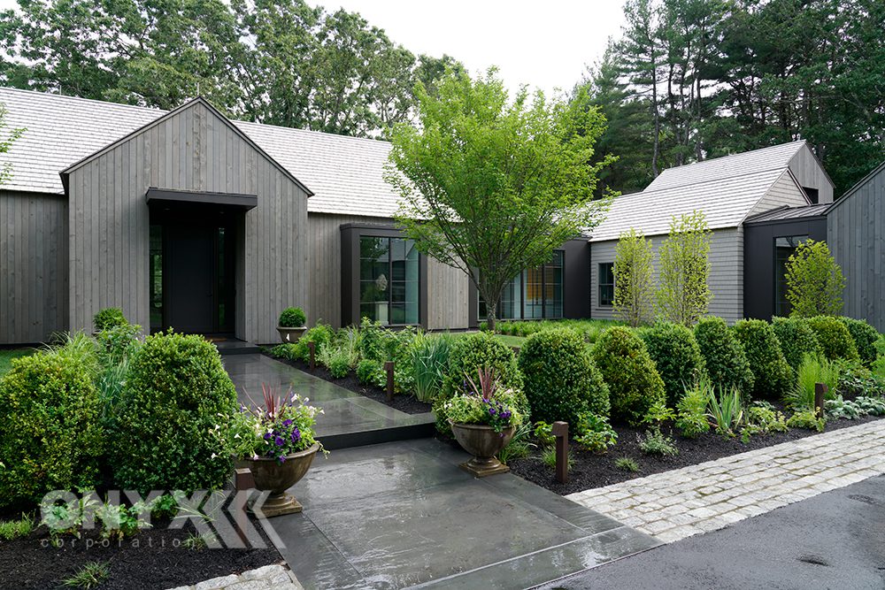 Contemporary wooden home with all-green landscaping
