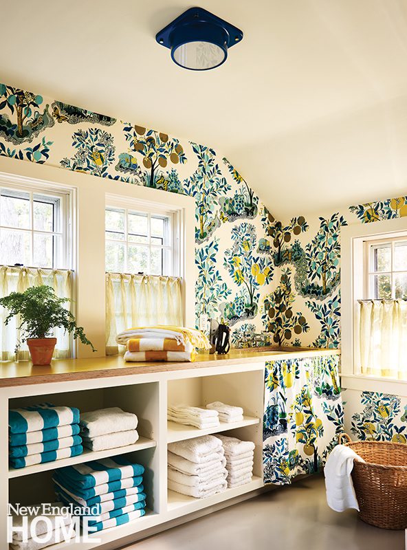 Laundry room with floral wallpaper and traditional details.