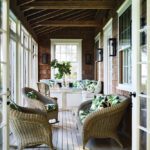 Narrow screened porch with a natural wood ceiling.