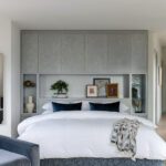 Bedroom with platform bed and built-in headboard.
