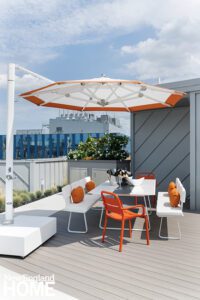 Boston rook deck with contemporary white furniture with orange accents.