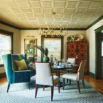 Dining room with eclectic furnishings and painted ceiling.