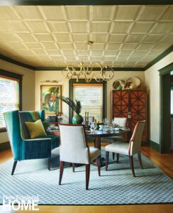 Dining room with eclectic furnishings and painted ceiling.