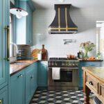 Kitchen with blue cabinetry and geometric floor.