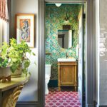 View to powder room with patterned wallpaper and floor.