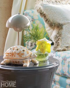Table top scene featuring a lamp and a ceramic turtle.