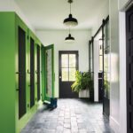 Mud room with bright green cabinetry.