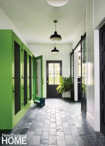Mud room with bright green cabinetry.
