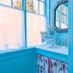 Powder room with wood painted a bright blue.