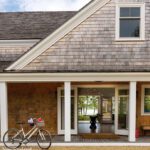 Exterior of shingle style home with a bicycle outside