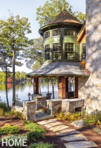 Outdoor stone porch overlooking a New Hampshire lake.
