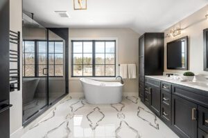 Large bathroom with a freestanding tub and black cabinetry.