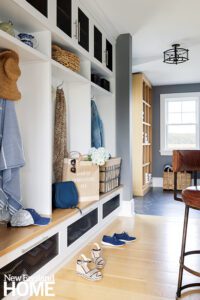 Mudroom with white cabinets and doors with a mesh front.