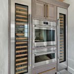Built in stainless steel wall ovens flanked by refrigerator columns.