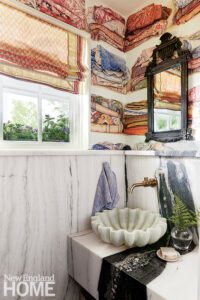 Powder room with marble sink whimsical wall paper