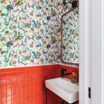 Powder room with Otomi wallpaper and bright red tile