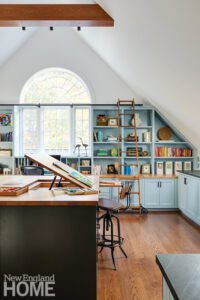 Artist's loft with bookcases painted light blue.
