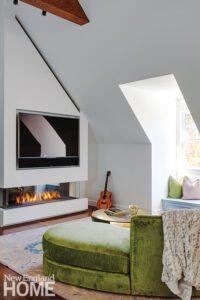 Seating area with a contemporary fireplace in an converted attic