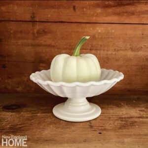 White footed bowl with a white pumpkin inside