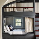 Bunk room with painted gray woodwork.
