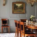 Dining room with gray paneled walls and a dark wood table