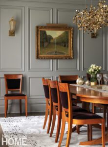 Dining room with gray paneled walls and a dark wood table