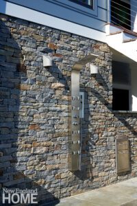 Outdoor shower with a stone wall