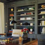 Home office with a walnut desk and custom cabinetry painted gray