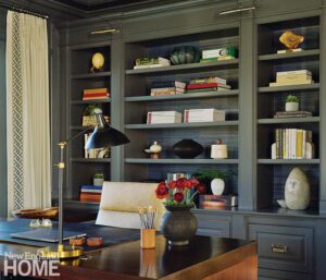 Home office with a walnut desk and custom cabinetry painted gray