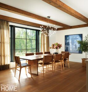 Dining room with a hand crafted dining table and rustic wood beams.