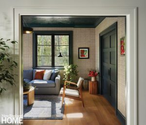 Cozy nook in a family room with beige walls and blue woodwork.