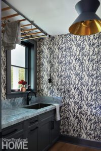 Laundry room with blue and white patterned wallpaper.