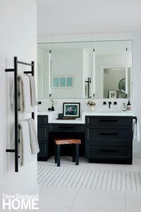 Bathroom with basketweave marble floor and black cabinetry