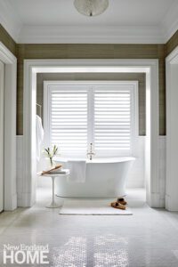 Large bathtub in front of a window.