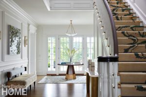 Large white entryway with a round pedestal table