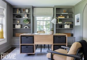 Masculine office with dark gray walls and cabinetry.