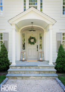 Entrance to a colonial home with a wreath on the door
