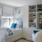 White bedroom with a built-in bed and custom cabinetry