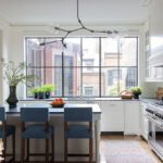 Kitchen with a large window with a view of Boston brick town houses