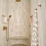 Curved shower with beige tile