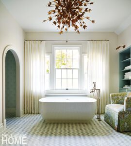 Large bathroom with a freestanding tub and marble mosaic floor
