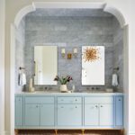 Light blue double vanity in an arched wall niche