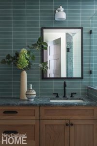Bathroom with natural cherry wood vanity and light blue tile