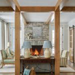 Living room with a stone fireplace and oak beams