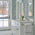 Bathroom with floral wallpaper and a white vanity and countertop
