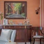 Traditional dark wood console and coral colored walls