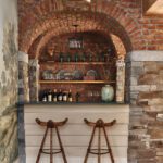 Home bar with brick walls and ceiling.