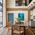 Two story dining room with light wood paneling
